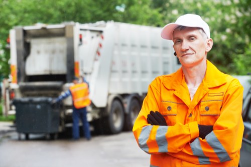 Construction workers managing builders waste clearance in Dalston